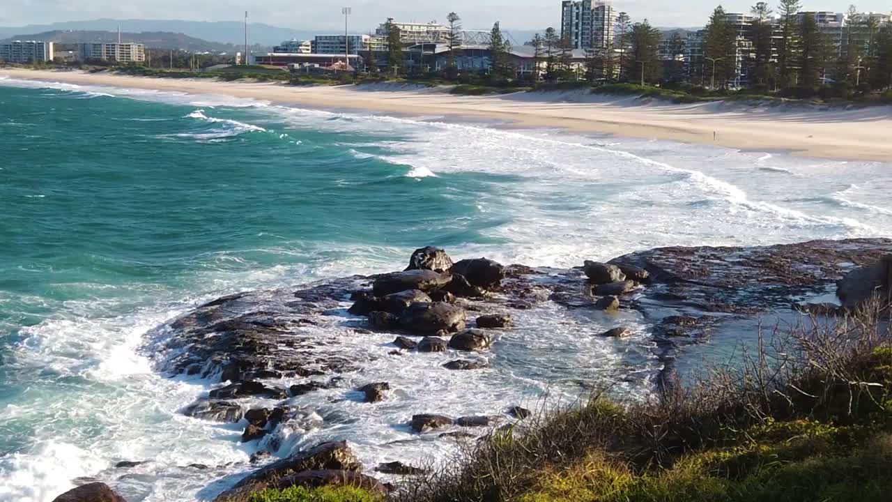 Slow motion ocean waves hitting rocky shore near the city of Wollongong, Australia.