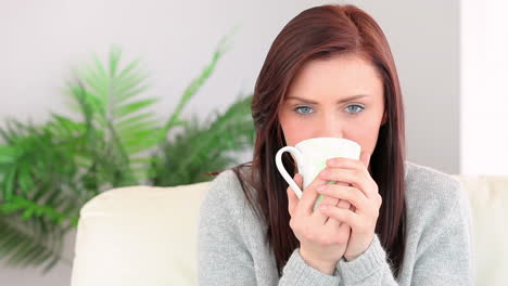 Pretty-young-woman-enjoying-coffee