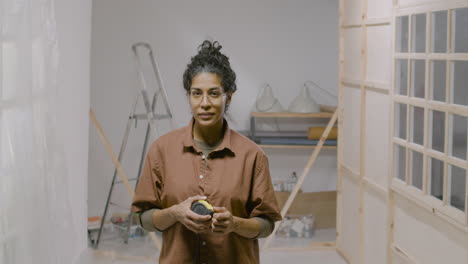 woman posing with measuring tape