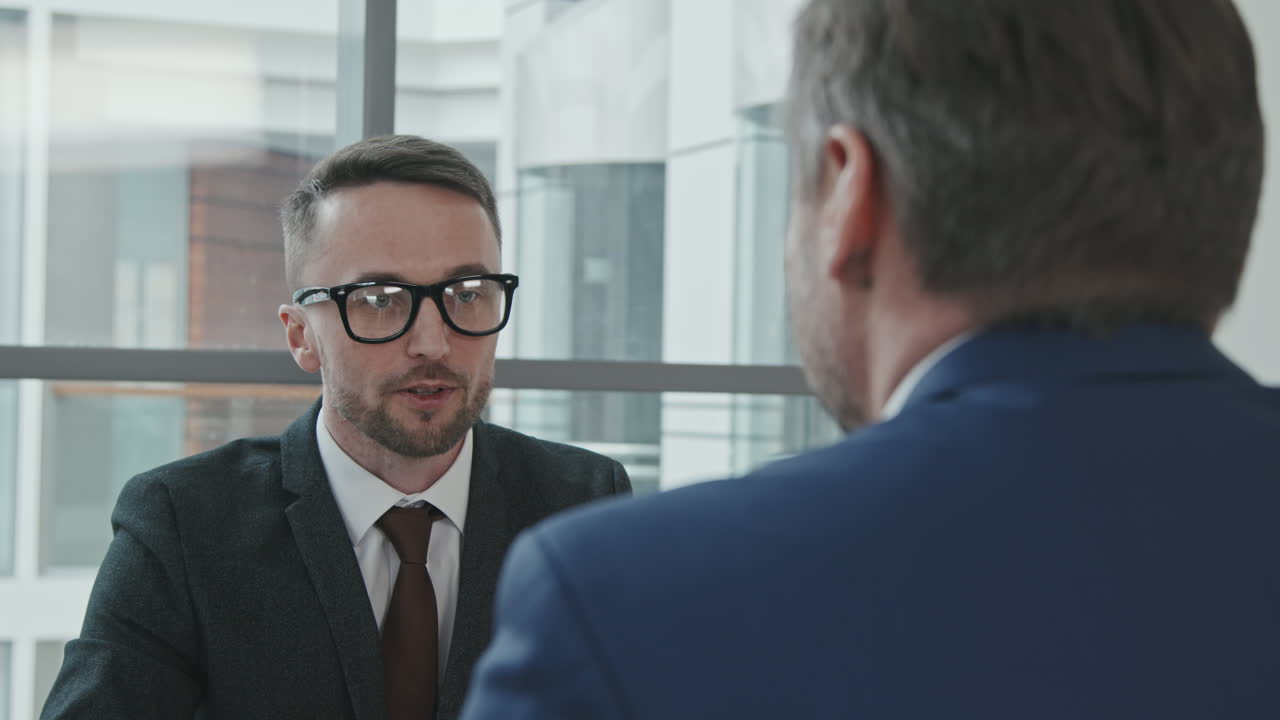Male Lawyer Consulting Client in Office