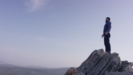 man standing on a mountain peak