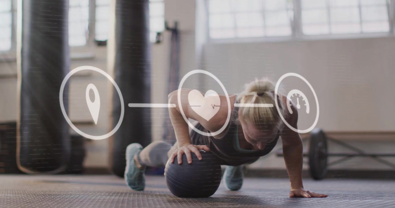 Woman starting on medball shifting weight rotating doing pushup for balance fitness icons over her