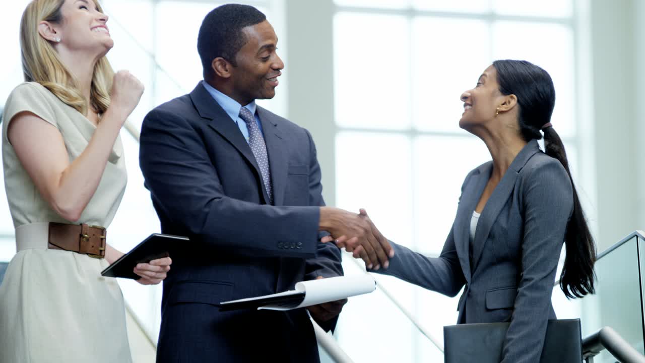 Successful multi ethnic business team using wireless technology