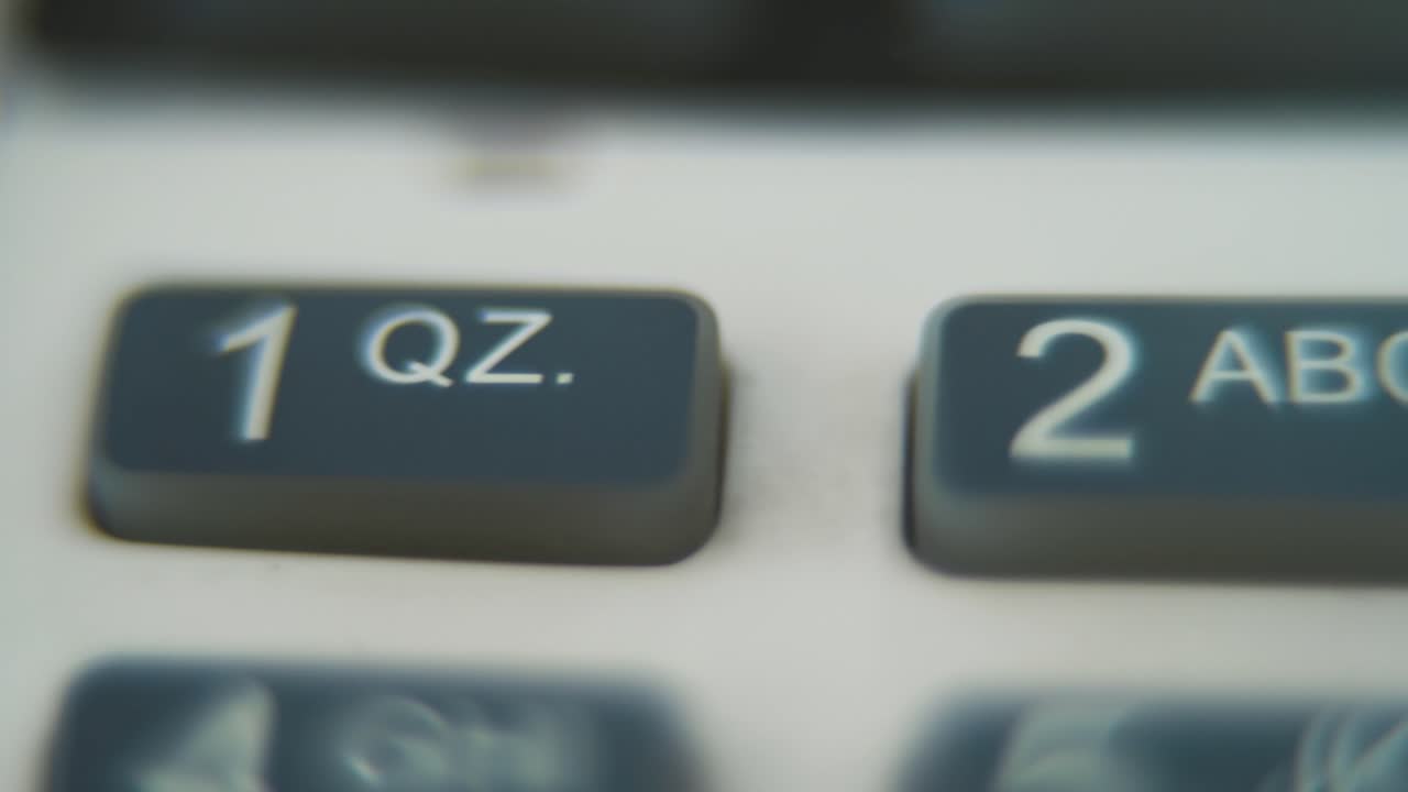A macro close up shot of a pin pad numbers and letters on colorful buttons, slide right movement, 4K video, depth of field