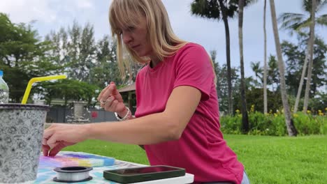 woman beading outdoors