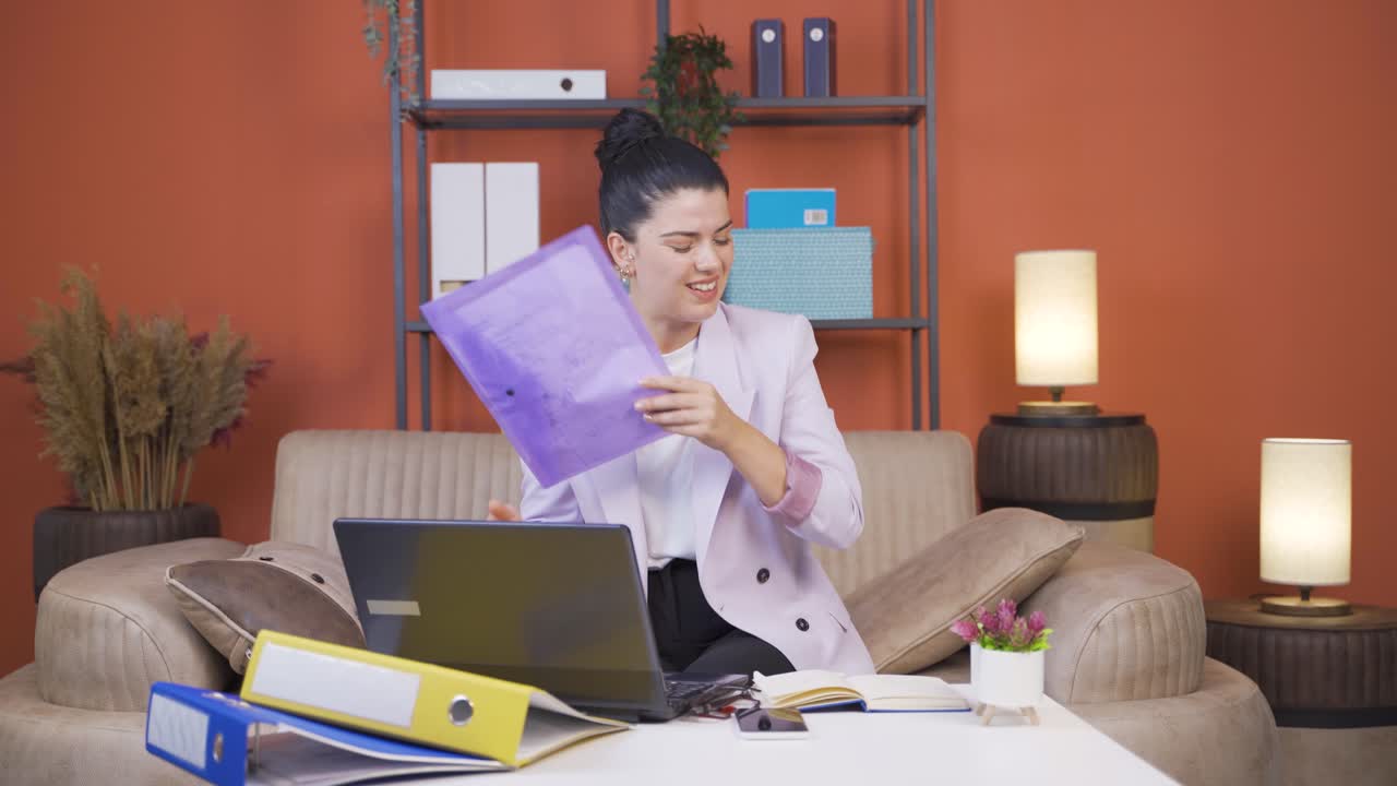 Home office worker young woman looking at the file angrily.