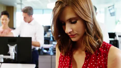 executive using digital tablet in office