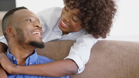 Woman-embracing-man-in-living-room