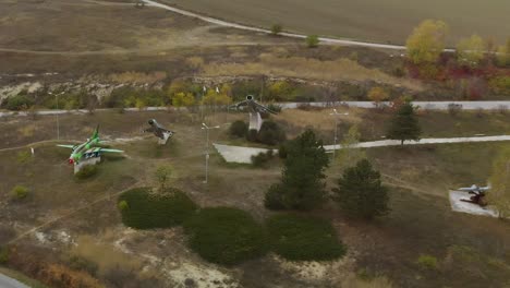 aerial panning footage of military airplanes outdoor museum exhibition-2