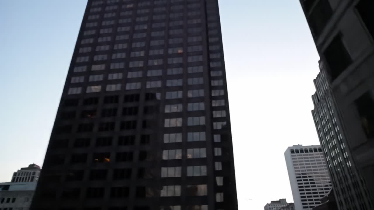 A Stunning Urban Landscape: Capturing the Transition from Dusk to Night in a Cityscape with Skyscrapers and Reflective Glass Facades Bathed in Evening Lights