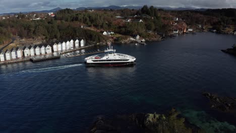 aerial shot over electric passenger ferry sailing through narrow waters - norway