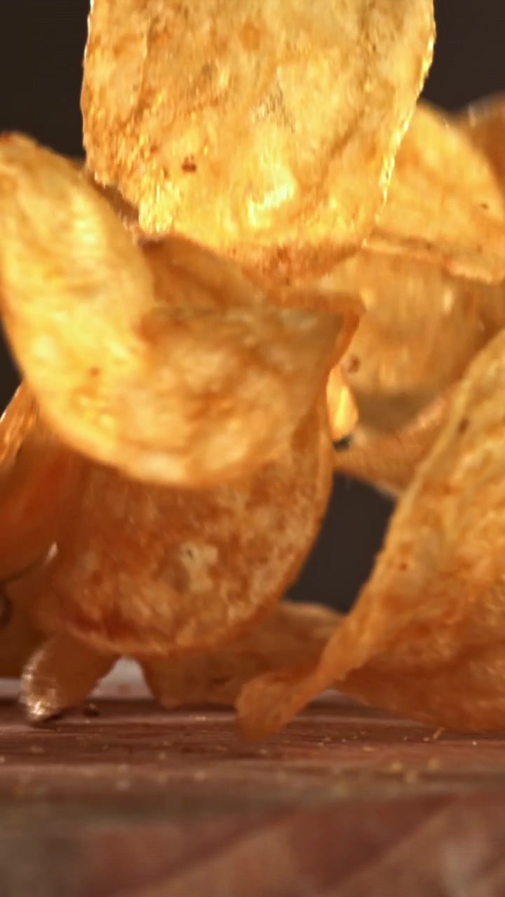 Crispy Golden Potato Chips Falling in Slow Motion