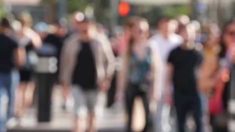 defocused crowd of people, road intersection crosswalk on the strip of las vegas, usa. anonymous blurred pedestrians on walkway in crowded urban downtown. unrecognizable american citizens in sin city