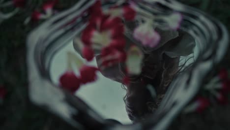 reflection of a woman in a floral arrangement
