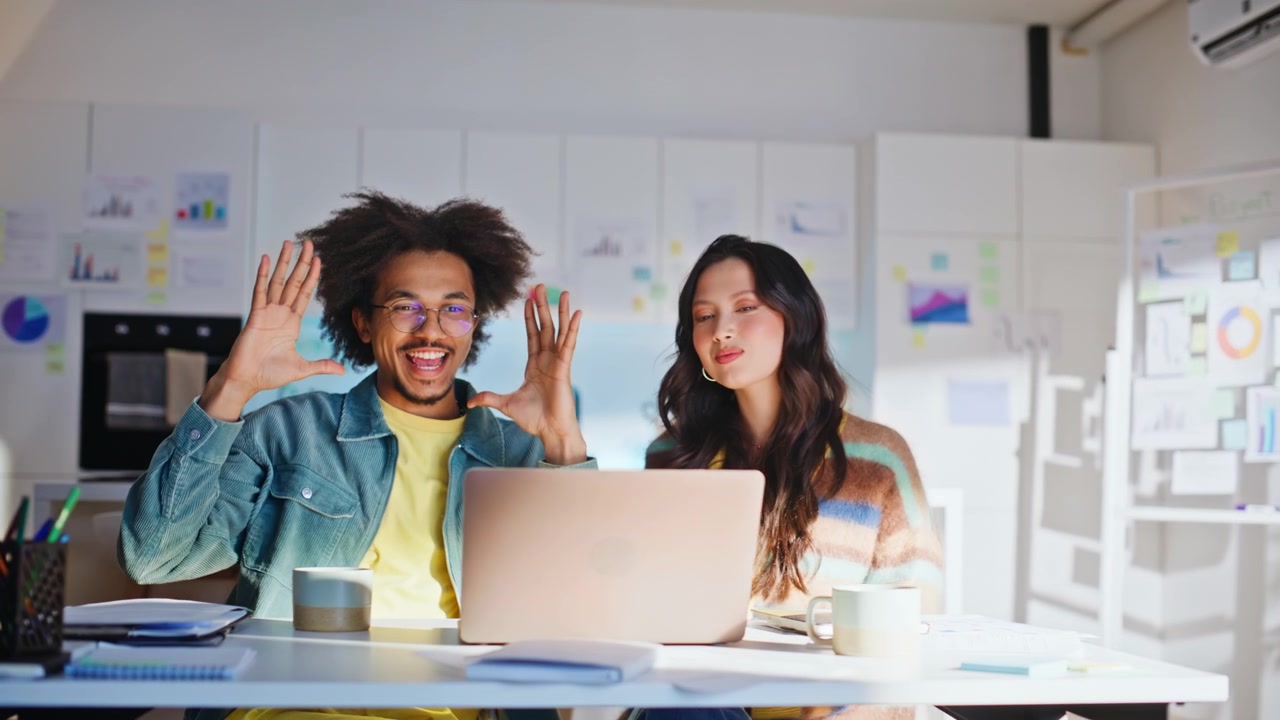 Startup team waving hand laptop video call. Multiracial coworkers online chat.