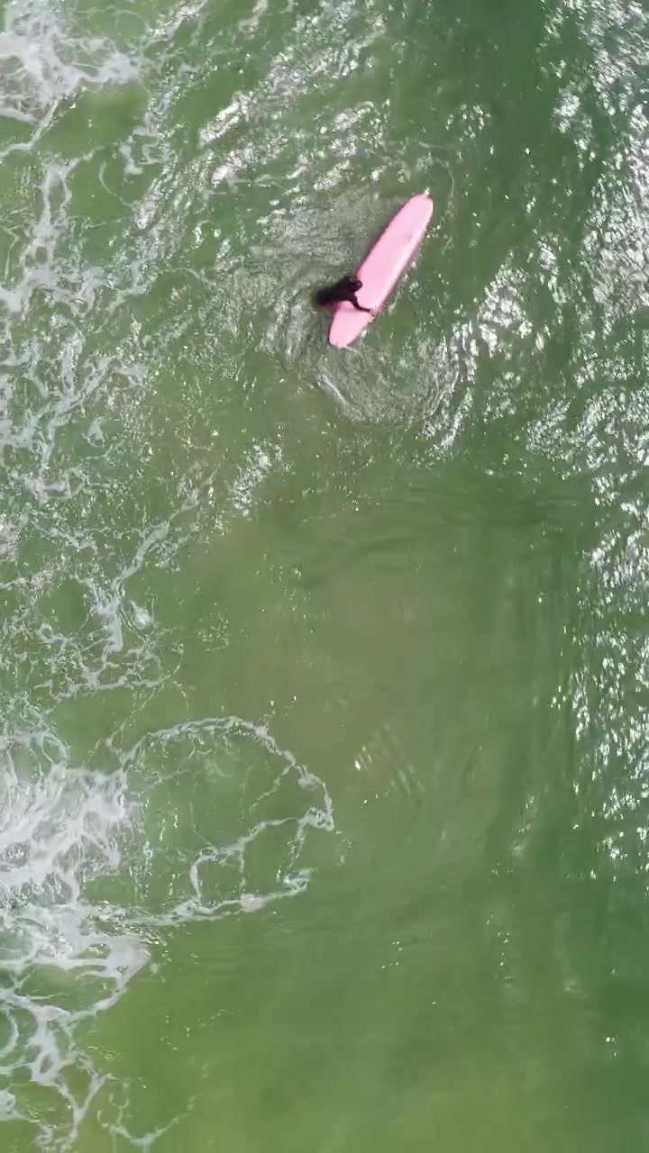 A Top-down View Of A Surfer Riding Crashing Waves Off The Coast Of Da Nang, Vietnam. Vertical, Aerial Shot