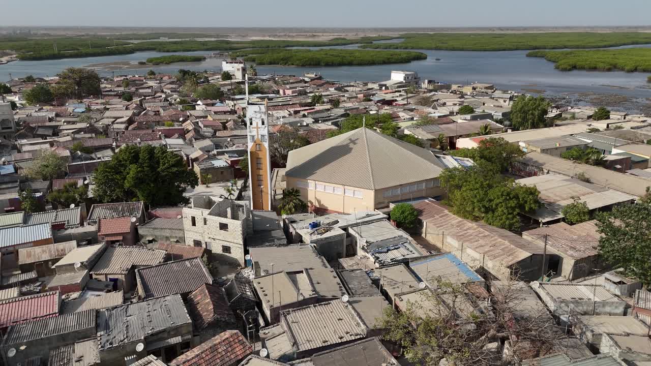 Drone close aerial of Joal village houses in Senegal, Africa representing rustic African lifestyle and cultural identity
