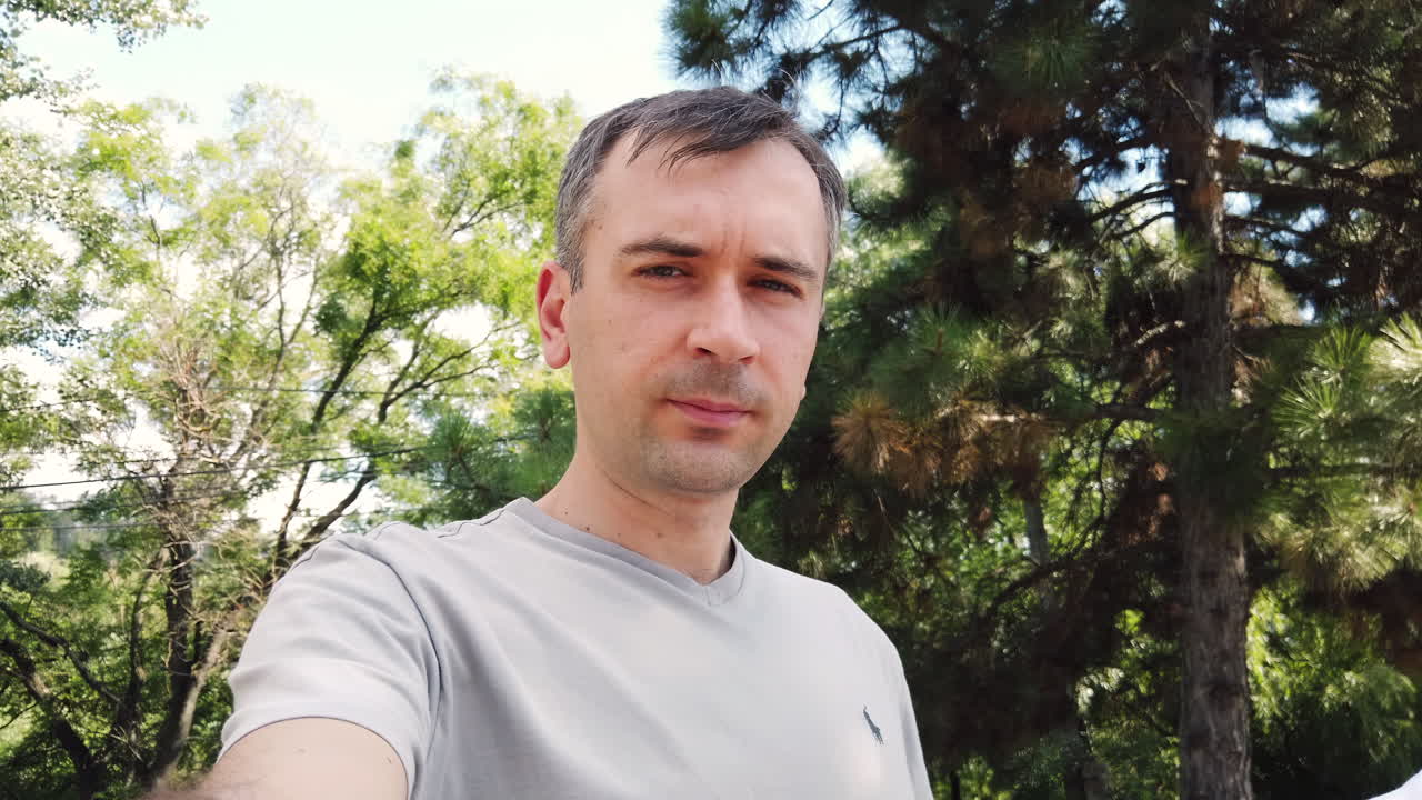 Friends enjoy a relaxing afternoon surrounded by lush greenery, capturing moments while appreciating the calm and beauty of nature in a peaceful setting