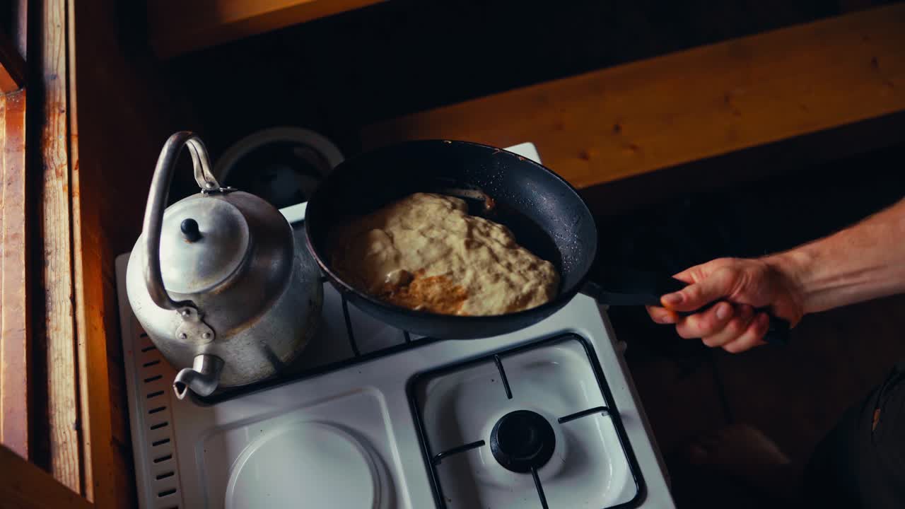 A Person is Pouring Pancake Batter Into a Pan in a Rustic Kitchen in Reinsjøen, Åfjord, Trøndelag, Norway - High Angle Shot