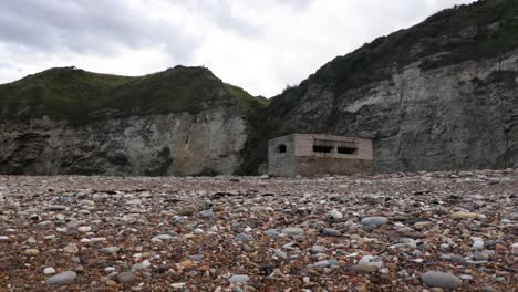 pillbox or guard post on beach in england from ww2 for coastal defence