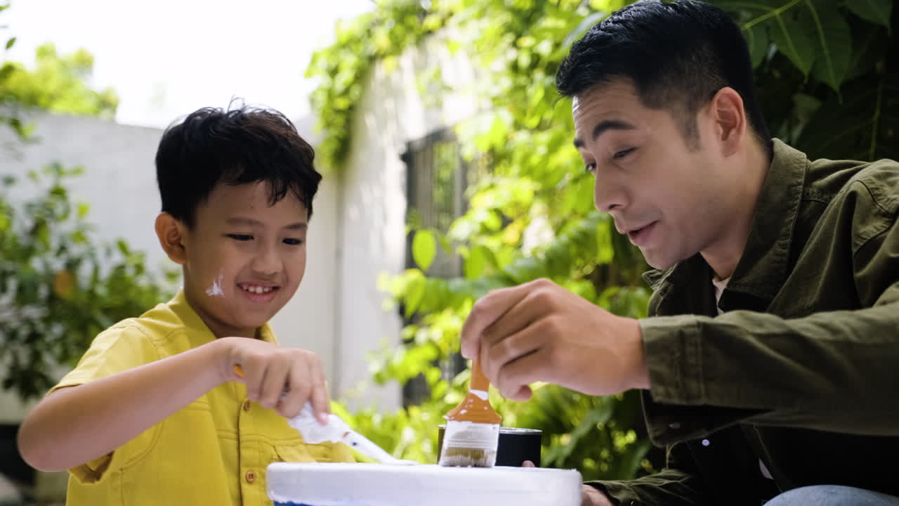 Asian man and boy in the backyard