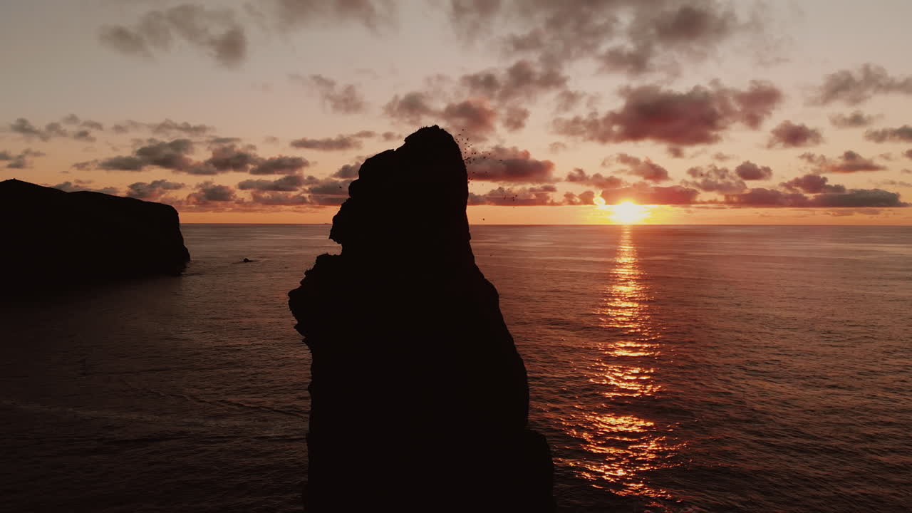 Sunset over Volcanic Island Coastline