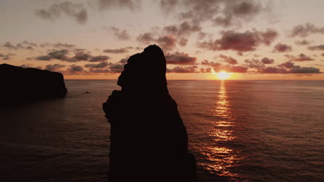 sunset over volcanic island coastline