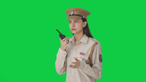 Indian-female-police-officer-talking-on-walkie-talkie-Green-screen