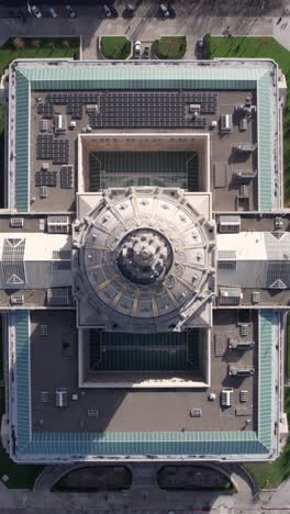 vertical drone shot of san francisco city hall, dome and rooftop from above, birdseye aerial view