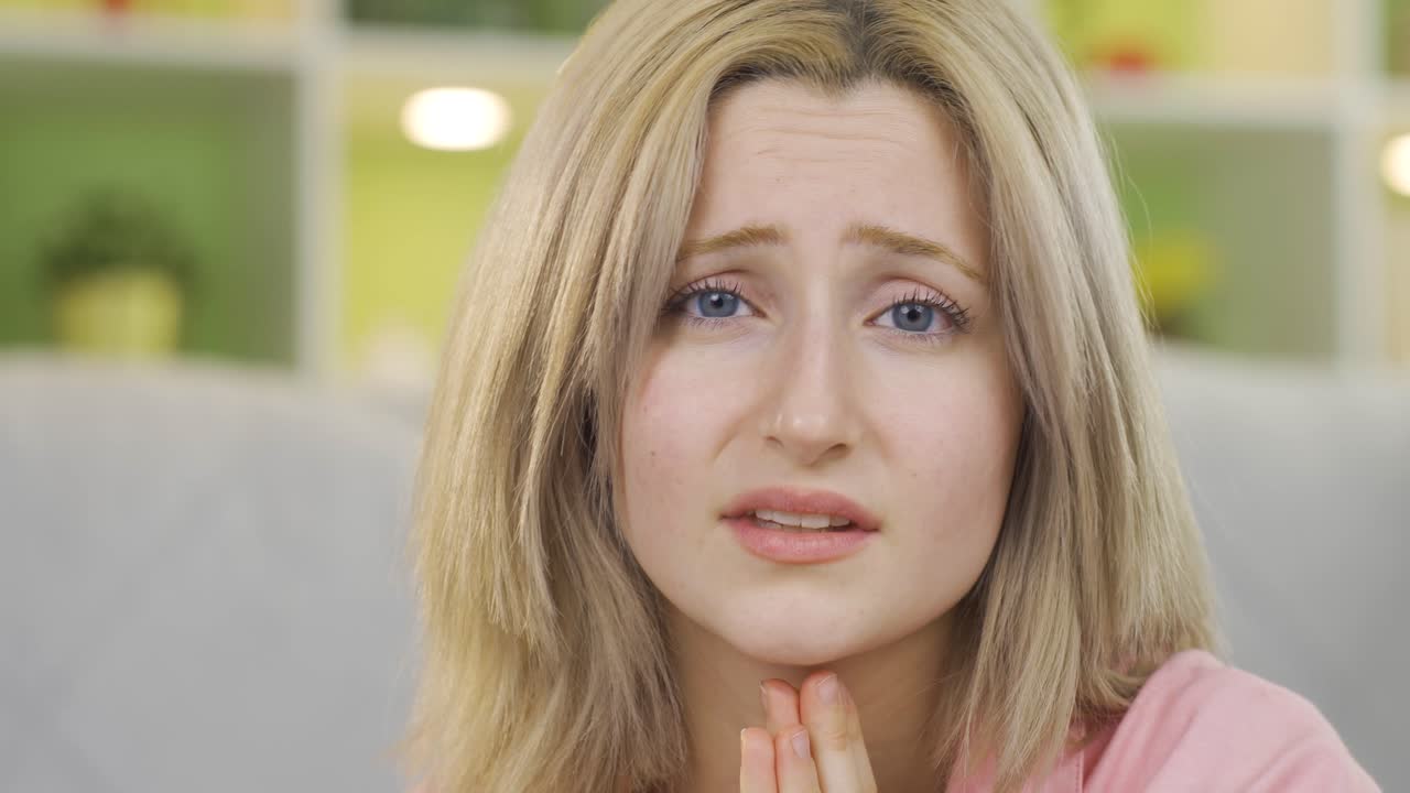 mujer joven rogando mirando a la cámara.