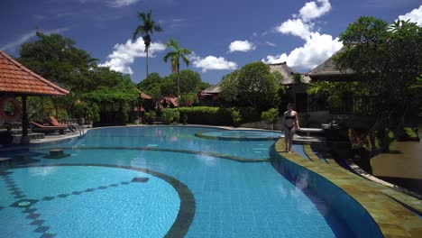 woman relaxing by a beautiful tropical pool