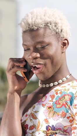 transgender person talking on mobile phone outdoors.