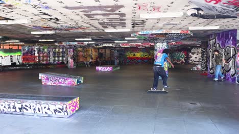 skateboarder performing tricks in urban skatepark