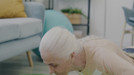 senior woman doing push-ups at home