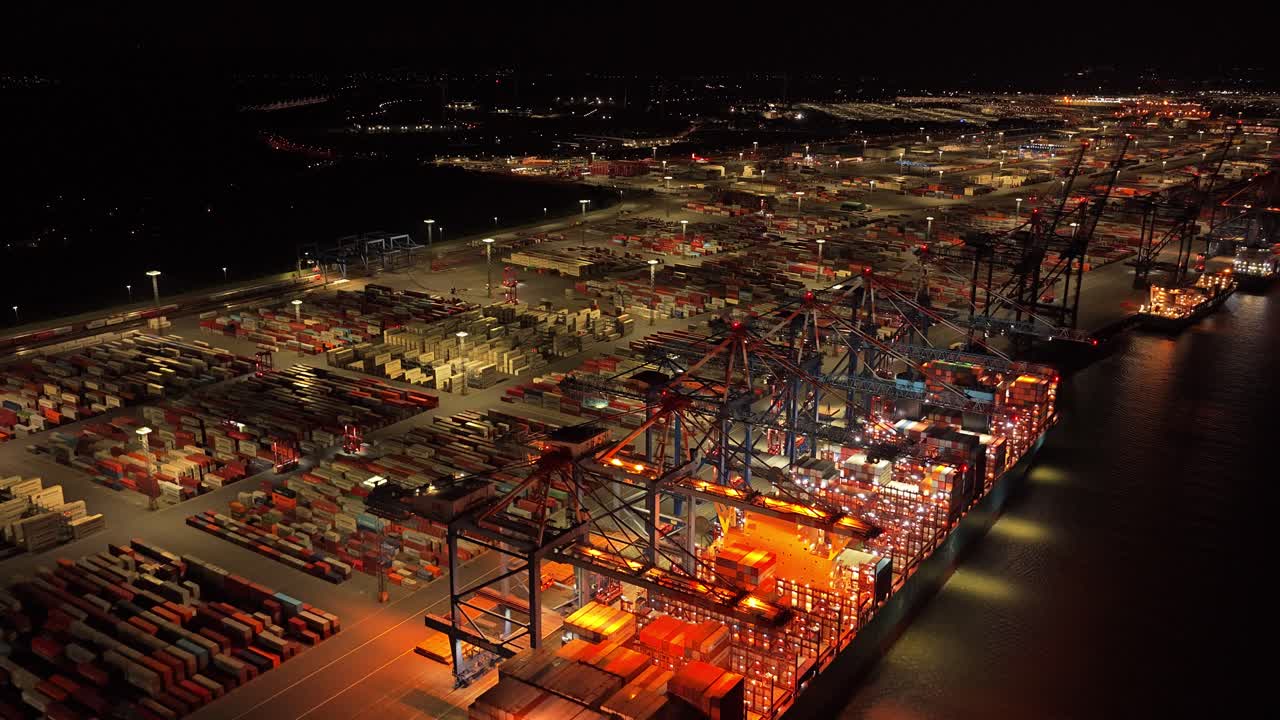 Night aerial of container terminal with heavy shipping activity