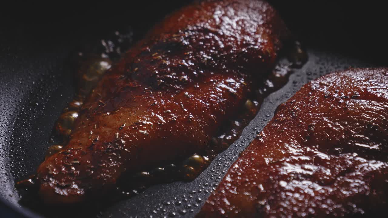Seasoned Uncooked Chicken Breast Frying In A Skillet