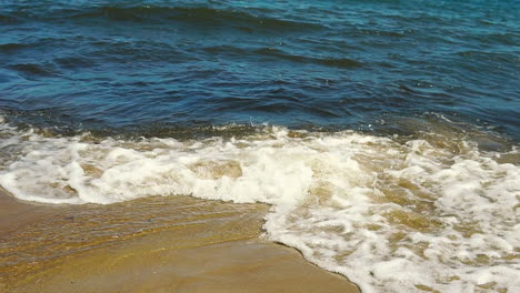 view of the sea shore, foam from water poured into the sand, sand and water on the coast
