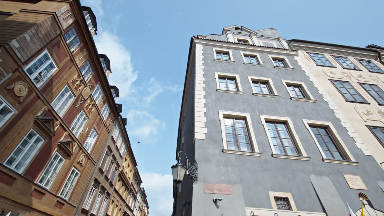 Historic buildings in the Old Town of Warsaw, showcasing colorful facades and blue skies