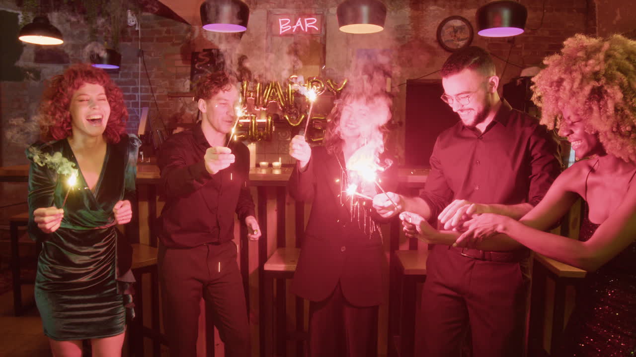 People celebrating with sparklers at a bar