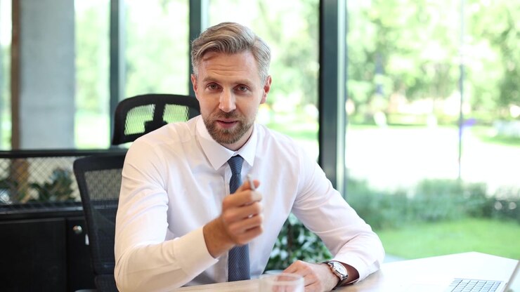 Confident Businessman Speaking and Gesturing in Modern Office