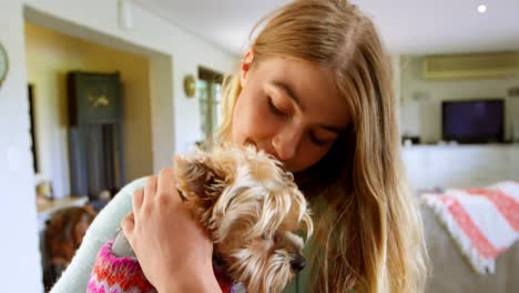 Woman-holding-her-dog-at-home-4k