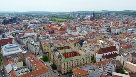 A-drone-flies-forward-to-aerial-view-of-Brno-City,-Czech-Republic,-with-its-famous-landmarks