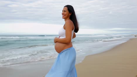 pregnant woman walking on the beach