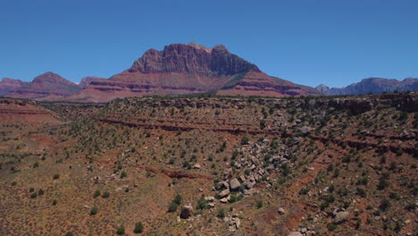 aerial view of rocky hillside approaching the purple mountains of zion located in southern utah, united states