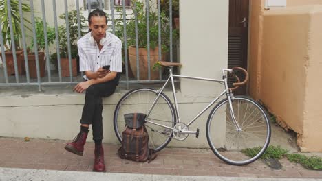 Mixed-race-man-using-his-phone-outside