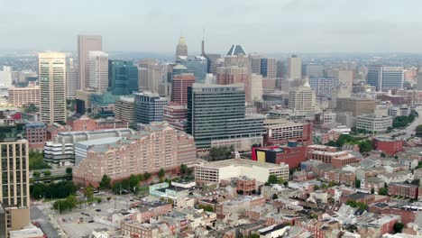 Wide-angle-aerial-truck-shot,-Baltimore-Maryland-USA,-establishing-shot-reveals-skyscrapers-and-homes-in-downtown-urban-American-city