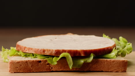 making a ham and lettuce sandwich
