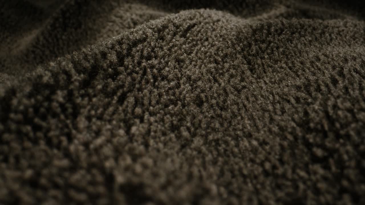 Close-up view of dark brown fabric texture