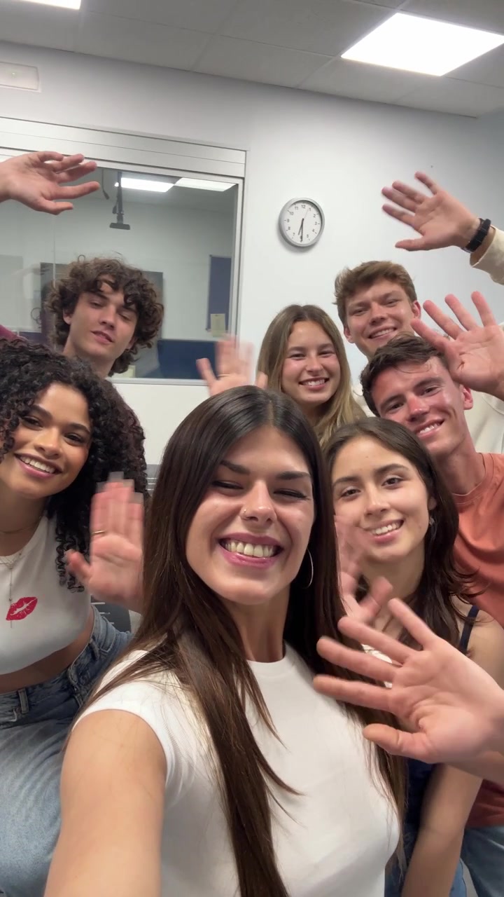 Happy Group of Young Students Smiling and Waving