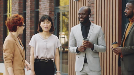 multiethnic business people speaking on street